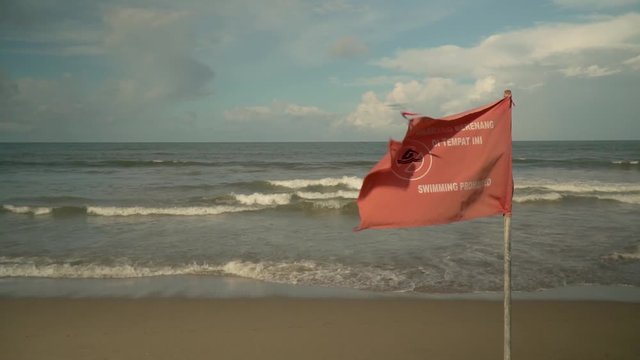 flag on the beach with the words swimming prohibited