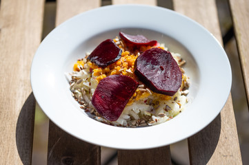 delicious salad on a white plate  with kohlrabi, beetroot, lentils and grains
