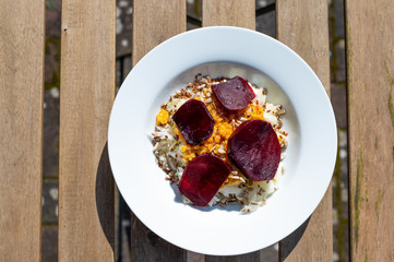 delicious salad on a white plate  with kohlrabi, beetroot, lentils and grains