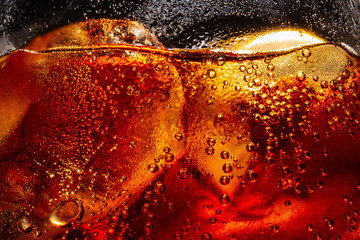 Soft drink glass with ice splash on dark background. Cola glass in celebration party concept