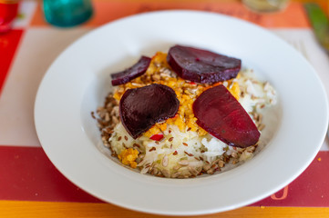 delicious salad on a white plate  with kohlrabi, beetroot, lentils and grains
