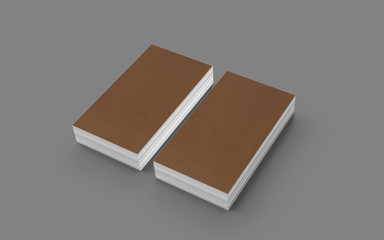 Blank cardboard business cards isolated on greyas template to showcase your design, logo, embossing etc.