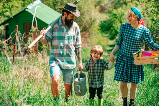 Rural Family Scene. Spring Farming. Earth Concept. Young Family With Child Having Fun In Nature. Family Gardeners. Happy Family On Farm.