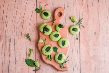 Shortbread cookies with mint, fragrant mint and sprigs of demen sedated on a wooden background.