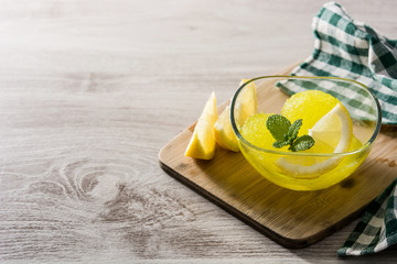 Lemon sorbet in glasses on white wooden background. Copy space