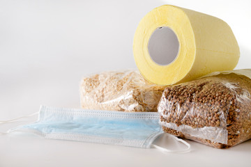 toilet paper, buckwheat, oat , cereals, medical mask on a white background, coronavirus epidemic