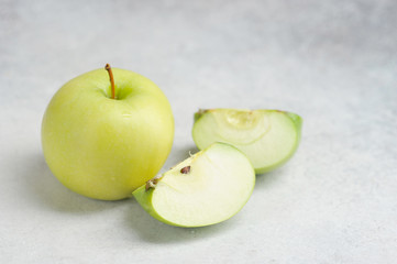one whole and cut green Apple