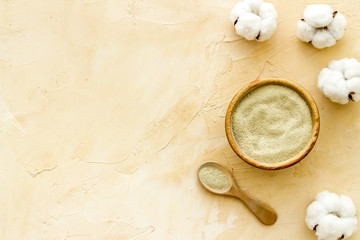 White cosmetic clay on beige background top-down copy space