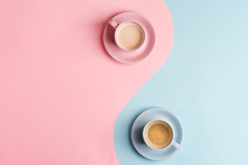 Creative pastel blue pink background as a symbol of infinity with two ceramic cups of freshly brewed coffee drink.
