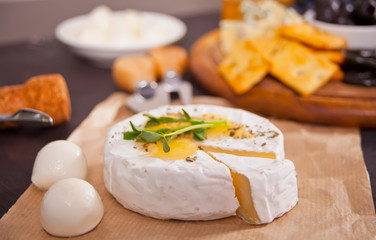 Camembert brie and mozarella cheese with honey and herbs. Dairy products.