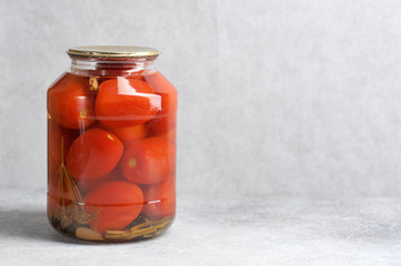 pickled red tomatoes in a glass jar