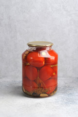 pickled red tomatoes in a glass jar