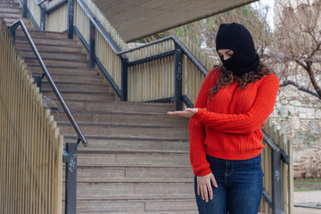 pretty caucasian young woman with ski mask copyspace imaginary on palm to insert advertisment, in...