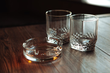 empty glasses for whisky and ash-tray