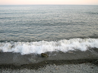 A flat horizon between the sky and the sea at sunset on a clear day.