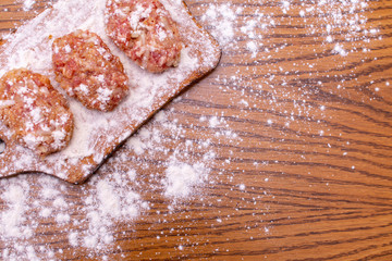 Cutlets lie on the board. View from above