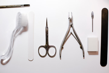 Manicure instruments set on white background top view