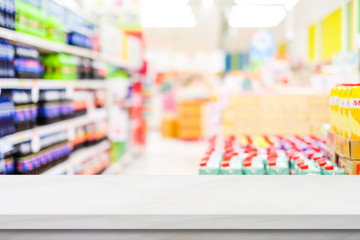 Grocery background, Empty white table top, counter, desk over blur perspective supermarket store with bokeh light background, White marble stone table, shelf and blurred shop for food, product display