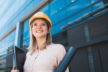 Professional architect woman standing outdoors.