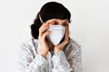 Coronavirus quarantine Covid-19 concept. Face of old sick woman wearing respirator mask for protect. Wuhan, China epidemic virus symptoms background.