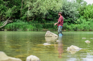Fototapeta na wymiar Good Things Come to Those Who Bait. fisherman with fishing rod. bearded fisher. hobby and sport activity. pothunter. mature man fly fishing. man catching fish. summer weekend. Big game fishing