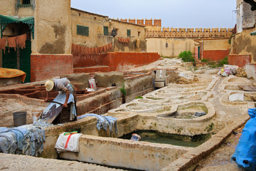 Courtyard with different stone vats with dye for leather in Tannery of Tetouan Medina. Northern...