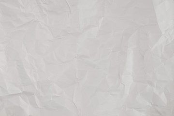 Crumpled white paper background.