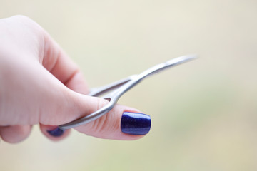 hand with manicure scissors