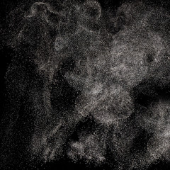 Movement of flying powder on a black background.
