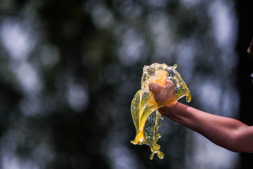 Hand with drinking water pours water. The conditions of the water and environmental crisis