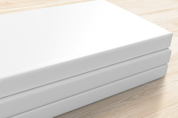 3 book with blank white hardcover on wooden desk background as template for your design presentation, promotion etc.
