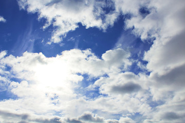 Obraz premium Beautiful cumulus clouds and bright real sun. Background. Landscape.