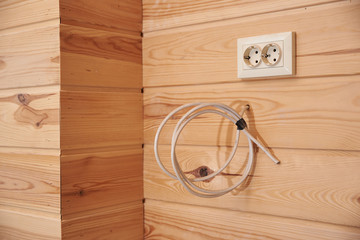 Electrical outlet and wires for connection on a wooden wall