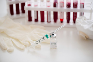 Test tubes with blood sample Covid-19 coronavirus. Vaccine and syringe injection It use for...