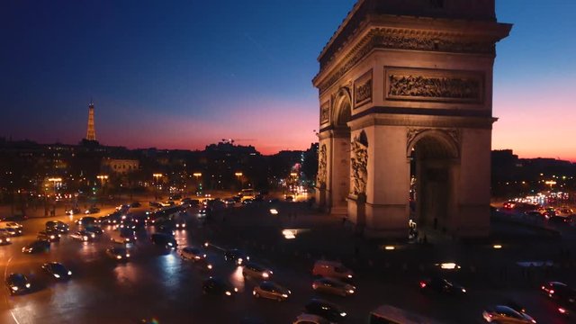 Aerial Paris dusk close up view of Arc de Triomphe Triumphal Arch, distant Tour Eiffel Tower view and Seine River, Paris city attractions in France