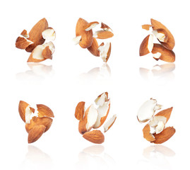 Group of crushed almonds in the air close-up, isolated on a white background