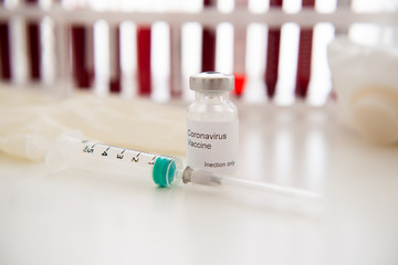 Test tubes with blood sample Covid-19 coronavirus. Vaccine and syringe injection It use for...