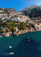 Fototapeta na wymiar Aerial panorama view of Amalfi coast. Rocky shores and incredible beaches, Luxury yachts, boats and apartments overlooking Tyrrhenian Sea. Bright sunny day. vertical photo. Positano, Italy