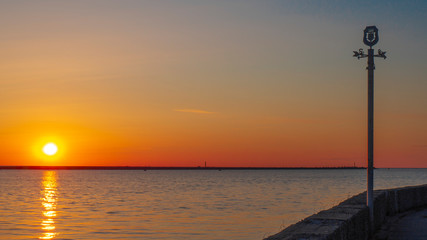 Pointer of the sides of the light against the background of the sunset