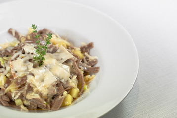 Pizzoccheri, a typical Italian pasta dish with cheese on white background
