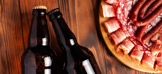 Beer snack in the form of meat products and bottled beer. Appetizer in the form of slicing bacon,...