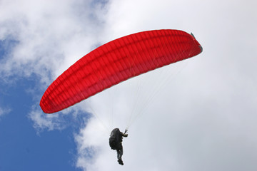 Paraglider flying wing in a blue sky	