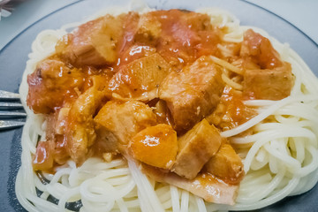 Meat gravy with pasta on a plate, closeup.