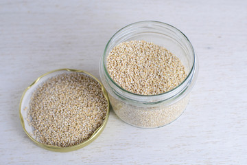 Gluten free quinoa close-up in a jar. Healthy source of protein nutrition. Vegetarian-based vegan diet. Emergency stocks - background. Organic ingredient for healthy smoothie bowls