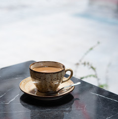 Breakfast. a Cup of fragrant coffee stands on a black marble table in a summer cafe in Istanbul