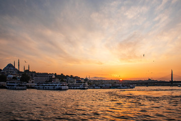 Fototapeta premium summer Sunny landscape in Istanbul on the sunset. Strait through the Bosphorus with a view of the blue mosque. A ship with tourists sails under the bridge