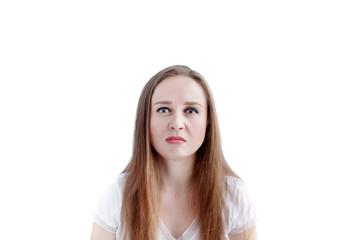 Confused young caucasian woman with disgusted facial expression and grimacing, isolated on white