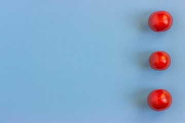 Set fresh vegetables,  tomatoes on a blue background.  Healthy food concept. Flat lay, top view. Copy space for text