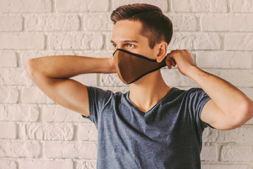 Hipster student wearing protective mask on face. Preventive measure against air pollution, nCov-19....