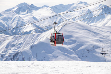 Fototapeta na wymiar Gudauri Ski Resort: Gondola (Ski Lift) and Snow-covered Caucasus Mountains in Distance - Gudauri, Georgia